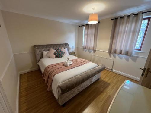 a bedroom with a bed with a stuffed animal on it at Super King Bed Suite, Executive office, fast WiFi, free parking in St. Ives