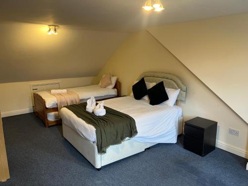 a bedroom with two beds in a attic at Super King Bed Suite, Executive office, fast WiFi, free parking in St. Ives