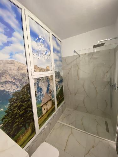 a bathroom with a shower and a window with a view at North Star Hotel in Shkodër