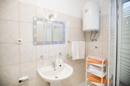 a bathroom with a sink and a mirror at House Kuca Carevina in Krušvar