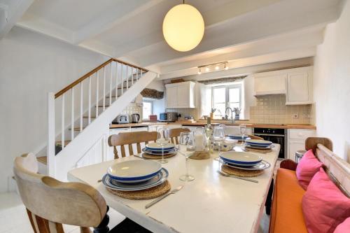 a kitchen with a table with chairs and a dining room at 3 Bed in Sennen oc-thbyre in Sennen