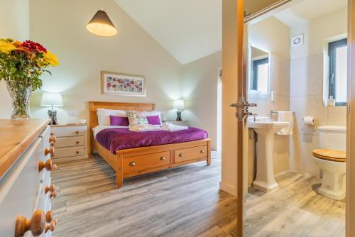 a bedroom with a bed and a sink and a toilet at 4 Bed in Heveningham oc-w29036 in Heveningham