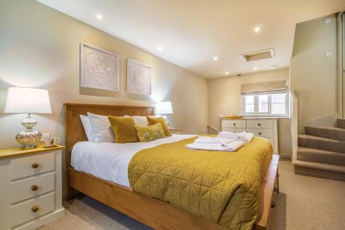 a bedroom with a large bed and a staircase at 2 Bed in Heveningham oc-w29034 in Heveningham