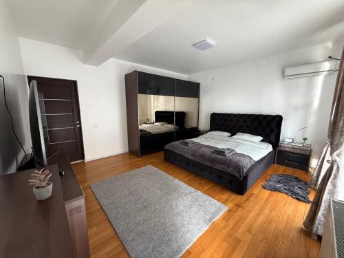 a bedroom with a bed and a mirror at Scandinavian AP in Craiova