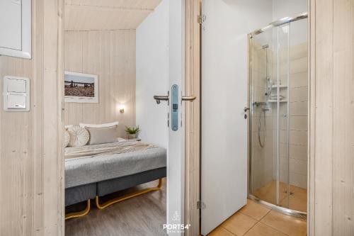 a bedroom with a bed and a shower at Ferienhaus Brocken - Sankt Andreasberg im Harz in Sankt Andreasberg