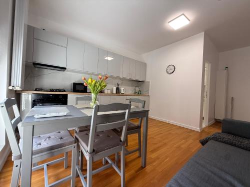 a kitchen and dining room with a table and chairs at Scandinavian AP in Craiova