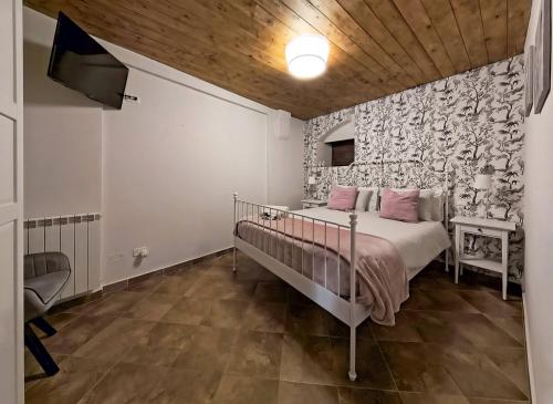 a bedroom with a bed with pink pillows at Dimoramica LTB in Foligno