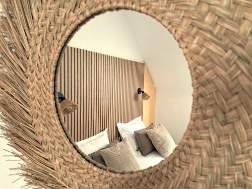 a mirror reflection of a room with a couch at Best Western Le Vinci Loire Valley in Amboise