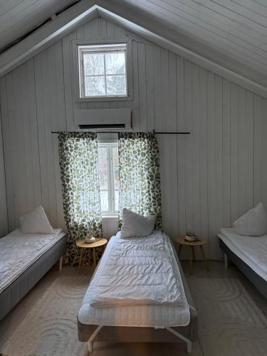 a room with two beds and a window at Mormors hus in Jörlanda