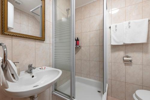 a bathroom with a sink and a shower at Villa Nick in Cavtat