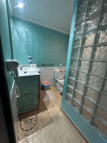 a bathroom with a sink and a toilet at Villa L'initiale in Oualidia