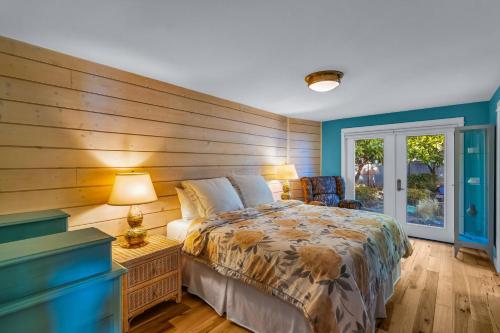 a bedroom with a bed with a wooden wall at Shaws Cove Beachouse in Gig Harbor