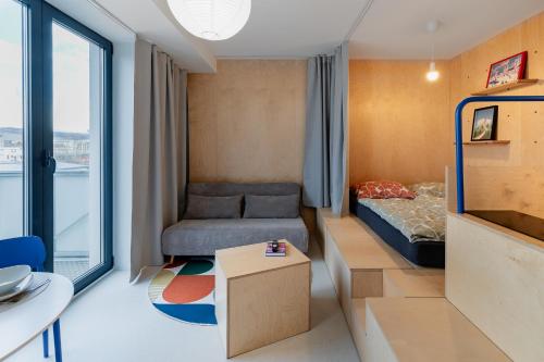 a small room with a bed and a table at Super apartmán - self check in, free private parking, balcony in Banská Bystrica
