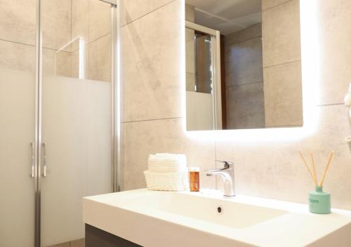 a bathroom with a sink and a mirror at Tower Suite Trento in Trento