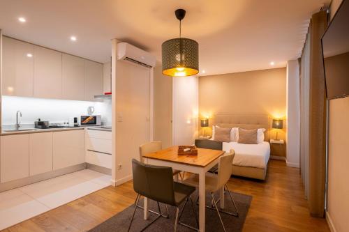 a kitchen and a bedroom with a table and a bed at Terro Collection - Anjo in Braga