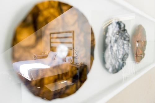 a reflection of a bed in a mirror at Hotel & Spa Princesa Munia in Oviedo