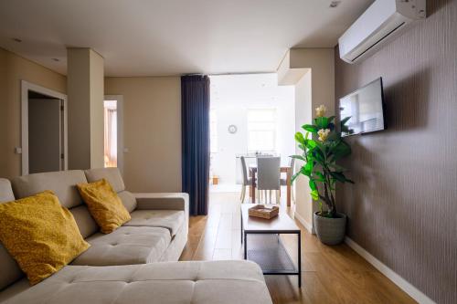 a living room with a couch and a table at Terro Collection - Anjo in Braga