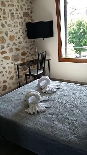 a hotel room with two swans on a bed at Palais Cathare in Bélesta