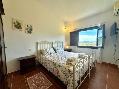a bedroom with a bed and a window at Country Guest House in Cardedu