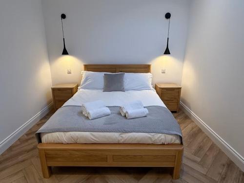 a bedroom with a bed with two towels on it at Old Library Apartments - 8a in Orkney
