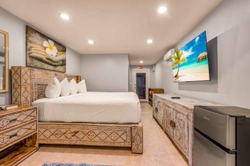 a bedroom with a large bed and a television at Largo Resort in Key Largo