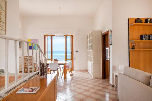 a living room with a view of the ocean at Villa Elvira - Apulian Stay Group in Faccia di Trippa