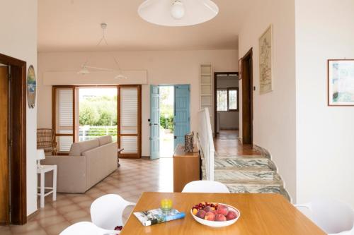 a kitchen and living room with a table and chairs at Villa Elvira - Apulian Stay Group in Faccia di Trippa