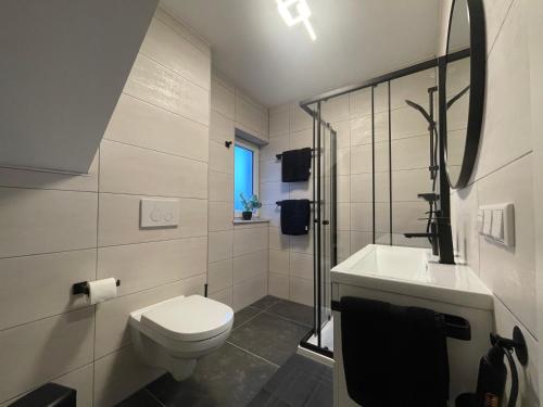 a white bathroom with a toilet and a sink at Ferienpark Worpswede in Worpswede