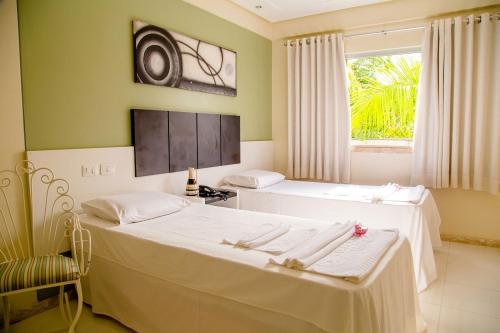 מיטה או מיטות בחדר ב-Eunapolis Plaza Hotel