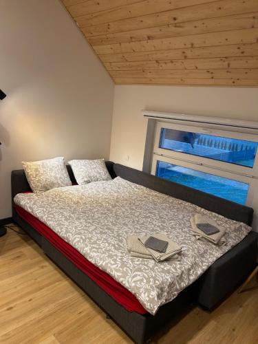 a bedroom with a bed with two books on it at Winnica Strzegocice SPA in Bielowy