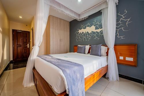 a bedroom with a large bed with a canopy at Divine Homes Resort Kisumu in Kisumu
