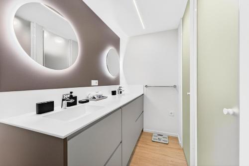 a bathroom with a white sink and a mirror at Seaview Oasis Luxury Duplex La Caleta in Adeje