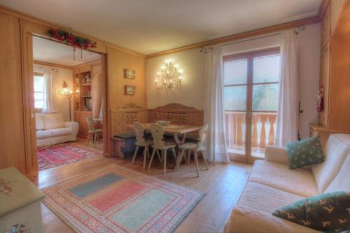 a living room with a table and a couch at Botton d'oro in Borca di Cadore