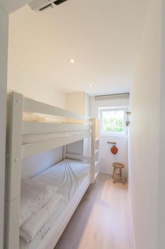 a bedroom with two bunk beds and a window at Lovely Duplex Axime with beautiful hill views - Malmedy in Malmedy