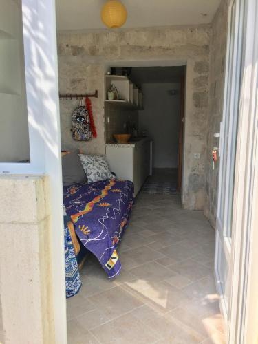 a bedroom with a bed in a small room at Boka Bay Beach House in Dražin Vrt