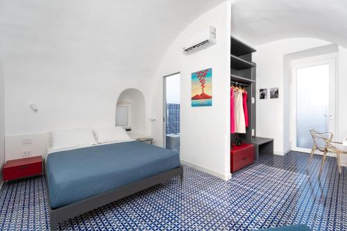 a bedroom with a bed and a dressing room at Domus Pio XI in Sant'Agnello