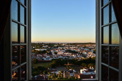 a view of a city from an open window at Pousada Castelo de Estremoz in Estremoz