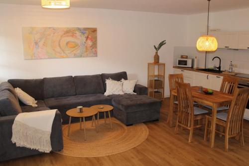 a living room with a couch and a table and a kitchen at Ferienwohnung Annette Mieth in Weitenhagen