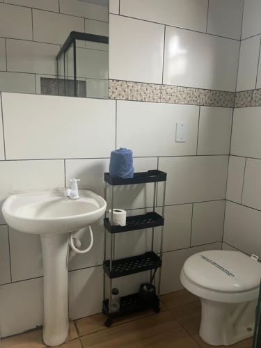 a bathroom with a sink and a toilet at Pousada Taylor in Foz do Iguaçu
