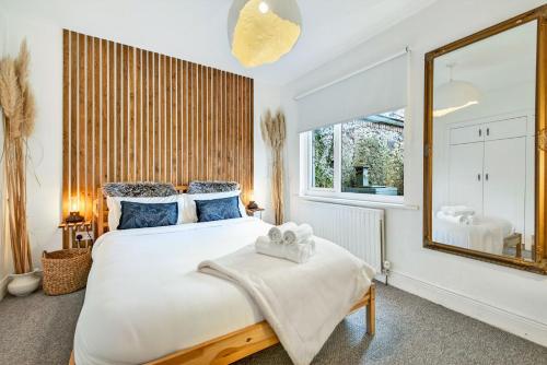 a bedroom with a large bed and a large mirror at Wolfe Tone Apartment in Sligo