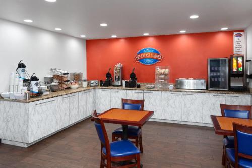 a fast food restaurant with tables and chairs at Baymont by Wyndham Green Bay in Green Bay
