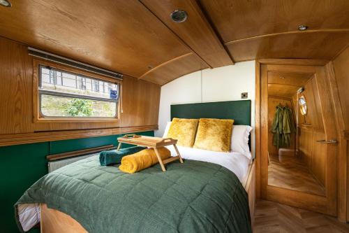 a bedroom with a bed with a wooden ceiling at Edinburgh - Houseboats in Edinburgh