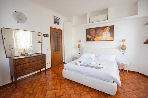 a bedroom with a bed and a dresser and a mirror at Casa Emi in Lezzeno
