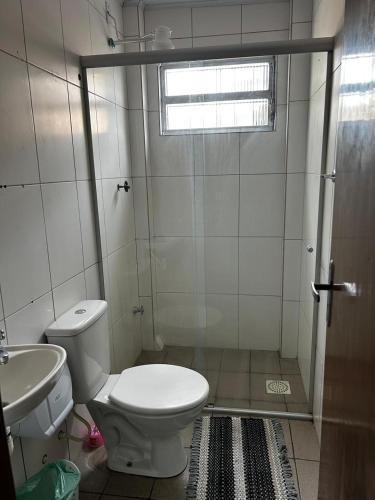 a bathroom with a toilet and a sink at HL Hotel in Pelotas