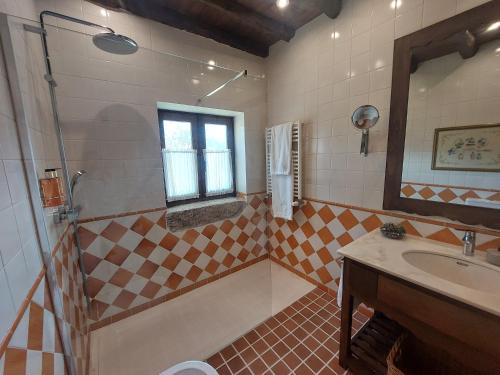 a bathroom with a sink and a shower at Casa da Terra - Gerês in Geres