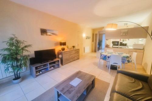 a living room with a couch and a table at 100 m from the beach prime location in Arcachon