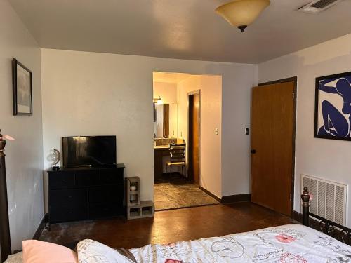 a living room with a bed and a television at Key to Austin Artistry in Austin
