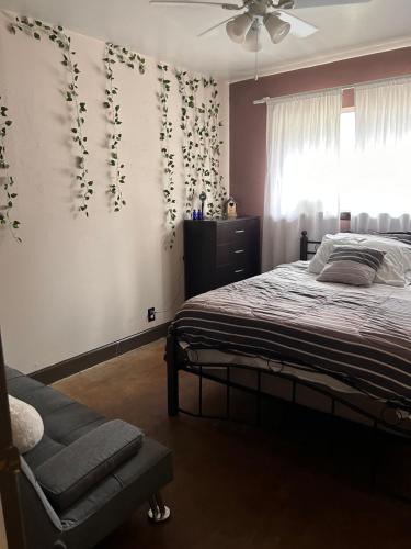 a bedroom with a bed and a ceiling fan at Key to Austin Artistry in Austin