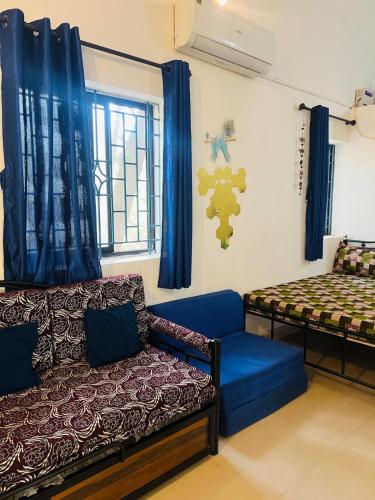 a living room with a couch and a bed at The Wilderness Studio! in Anjuna