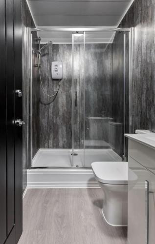 a bathroom with a shower and a toilet at The Wallace Suite by The Wallace Monument in Stirling